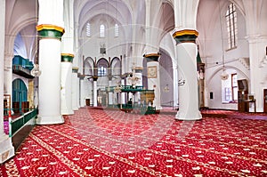 Nicosia, Cyprus - Oct 4 2018: Beautiful red and white interior of islamic Selimiye Mosque in Cypriot Nicosia. White walls, columns