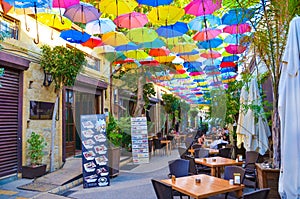 Nicosia, Cyprus - Oct 4th 2018: Outdoor cafe with amazing colorful umbrellas decorating the top of the street