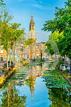 Nieuwe Kerk church viewed behind a channel in Delft, Netherlands