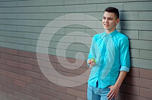 Nifty guy on the azure shirt and blue jeans hand holding relaxi