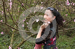 A nifty woman and Peach Flower photo