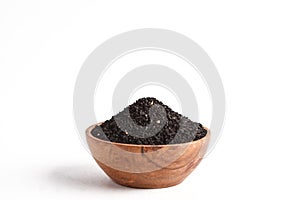 Nigella sativa or Black cumin in wooden bowl on white background