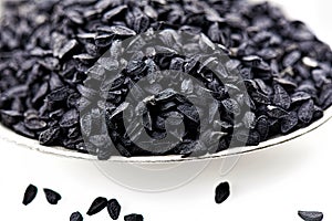 Nigella seed close up, isolated on white background