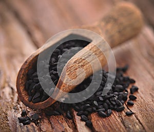 Nigella seeds in wooden scoop