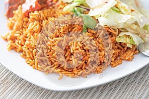 Nigerian African Jellof rice served with vegetable Salad