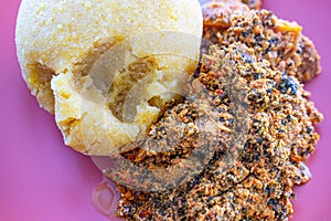 Nigerian Egusi Melon soup with garri eba for lunch photo