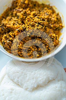 Nigerian Egusi Melon soup served with Tuwon Shinkafa