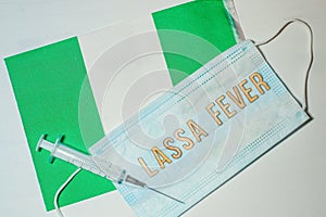 Nigerian flag under words Lassa fever outbreak concept. protective breathing mask and syringe. Lassa hemorrhagic fever LHF endemic