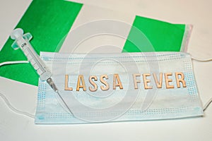 Nigerian flag under words Lassa fever outbreak concept. protective breathing mask and syringe. Lassa hemorrhagic fever LHF endemic