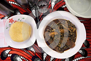 A Nigerian meal of Yellow Eba and Vegetable soup - Top View photo