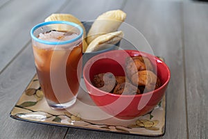 Nigerian Puff Puff and meatpie snacks served with iced tea