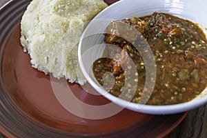 Nigerian Spicy Okro and Pepper stew served with Eba ready to eat photo