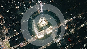 Night aerial overhead the Empire State Building spire illuminated New York City