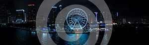 Night aerial panorama Miami Skyviews ferris wheel at Bayside Marketplace reflection in water