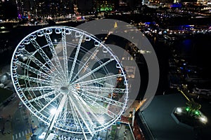 Night aerial panorama Miami Skyviews ferris wheel at Bayside Marketplace reflection in water