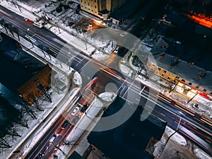 Night aerial view of crossroad with circular cars in small european city