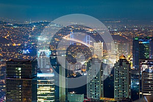 Night Aerial view of the illuminated city, skyscrapers and bridg