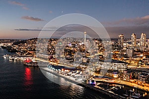 Night aerial view of illuminated Seattle Downtown and the Waterfront pier area with famous Space Needle