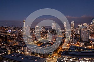 Night aerial view of illuminated Seattle Downtown and the Waterfront pier area with famous Space Needle