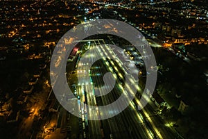 night aerial view over long railway freight trains with lots of wagons stand on parking