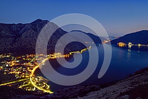 Night aerial view of seashore of Boka Kotorska in Montenegro at blue hour. Wonderful twilight Adriatic seascape over Kotor bay.