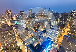 Night aerial view of Vancouver skyscrapers from city rooftop - B