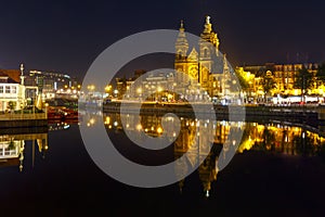 Night Amsterdam canal and Basilica Saint Nicholas