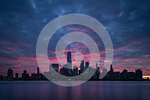 Night atmosphere with red pre-sunrise clouds above Lower Manhattan cityscape