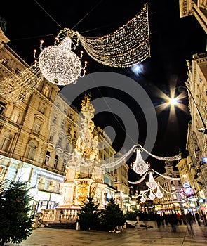 Night Atmospheric View, Motion Blurred of Graben, Busy Crowded Vienna`s Shopping Street with Memorial Plague Column Pestsaule