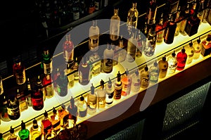 Night bar full of expensive bottles of alcohol