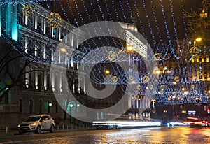 Night in the big city, the cars traveling on the highway and shines a blinding light. City, Kiev - december, 2017