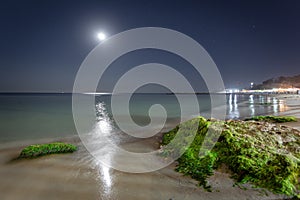 Night Black sea landscape in Odessa with moon reflection and colored stones