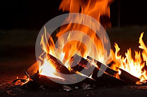 Night Bonfire: Fire Sparks Flying from Campfire into the Dark.