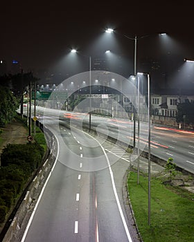 Night bright lights and vehicles in transit. Sao Paulo city highway beside the river. Skyline, cars and traffic on