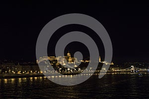 Night Budapest at the river Danube. Buda Castle Royal Palace and Chain bridge Szechenyi lanchid on background. Hungary