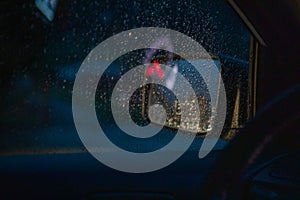 night car driving rain drops on window