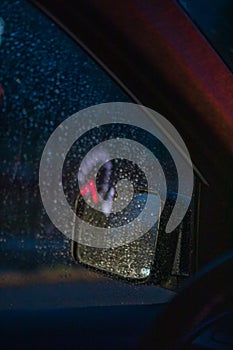 night car driving rain drops on window