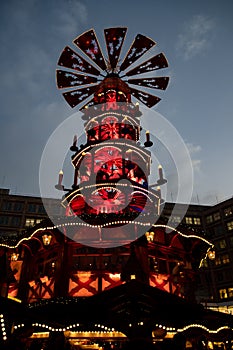 Night Christmas lights of traditional wooden carousel of nativity scenes in Berlin Germany. Fairy tale lighted Christmas pyramid