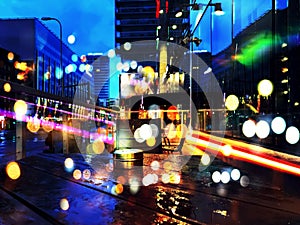 Night city blurred light building  street wet asphalt after rain urban lifestyle car traffic colorful  light