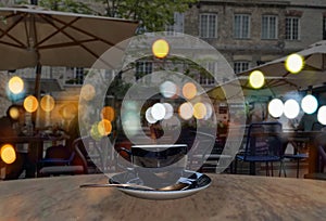 Night city life cafe where people relaxing under tent neon  blurred street lamp light in medieval Tallinn Old Town Estonia