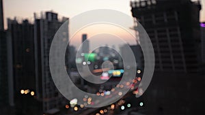 Night city lights and traffic in Bangkok as abstract background. Out of focus with blurry car and business building light, bird ey