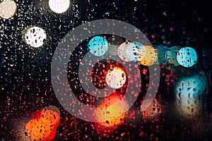 Night city lights, traffic in the rain, bad weather, abstract defocus background, bokeh effect