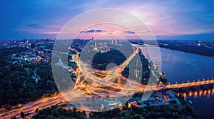 Night city panorama of the Kiev city with the Paton Bridge and the Dnieper River. Ukraine