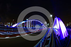 A night city street near the illuminated bridge in Tokyo wide shot