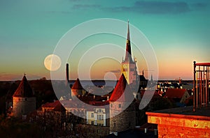 Night city  Tallinn old town red roofs medieval panorama  moon skyline  clouds blue sky sun down summer  weather Baltic sea on hor