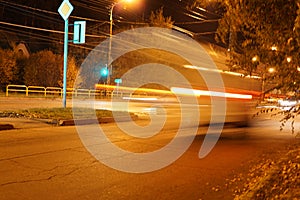 Night city traffic blurred lights headlight road trees autumn lights fanlights lighting cars foliage bush glare background