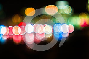 Night city traffic in a giant metropolis.City light bokeh background.Defocused night traffic lights.