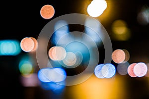 Night city traffic in a giant metropolis.City light bokeh background.Defocused night traffic lights.