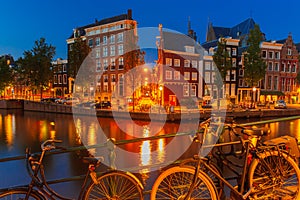 Night city view of Amsterdam canal and bridge