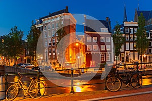 Night city view of Amsterdam canal and bridge